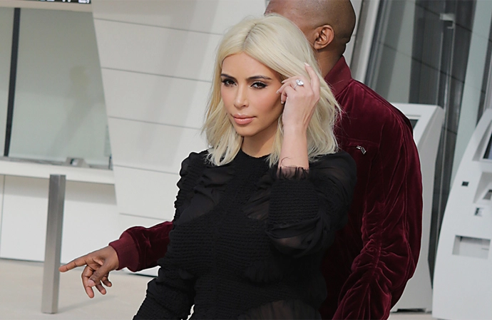 Kim Kardashian posed in the black-and-white looks surrounded by black inflatables