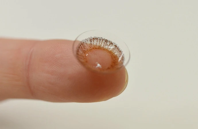 Scientists have improved ordinary contact lenses with ones that enable people to see in the dark