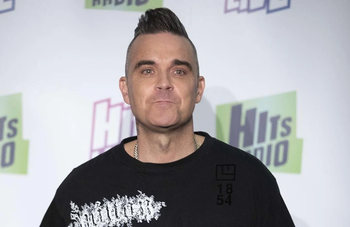 Robbie Williams would say yes to playing Glastonbury's legends slot