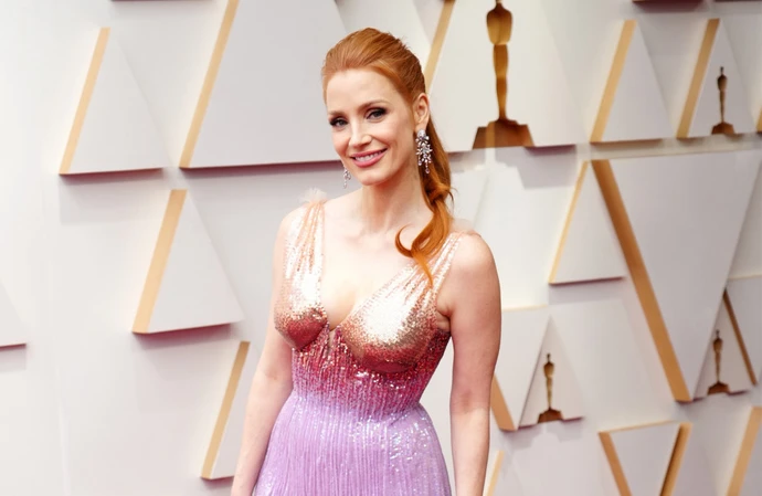 Jessica Chastain walks the red carpet at the Academy Awards