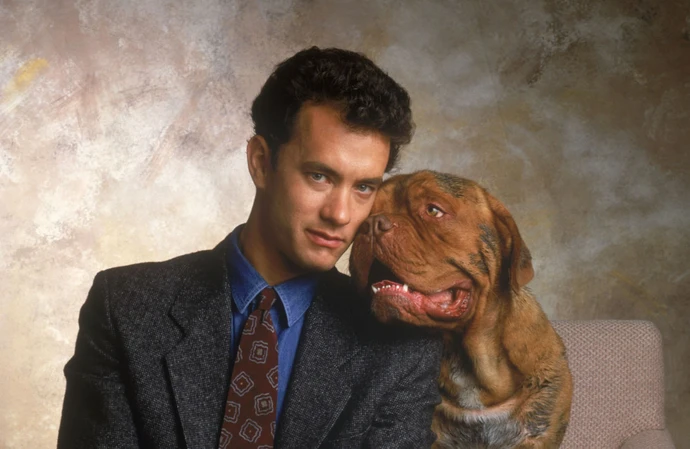 Tom Hanks had a hard time getting the dog collar on and securing the mutt in the car