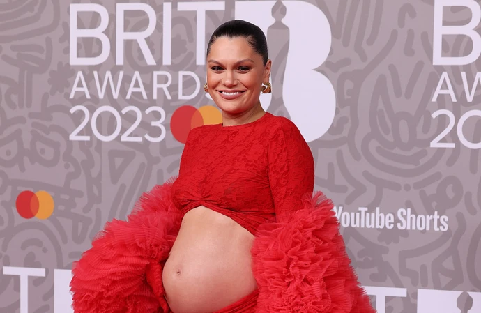 Pregnant Jessie J joked she was desperate for a snack as she turned up on The BRIT Awards 2023 red carpet in a cut-out dress designed to show off her growing baby bump