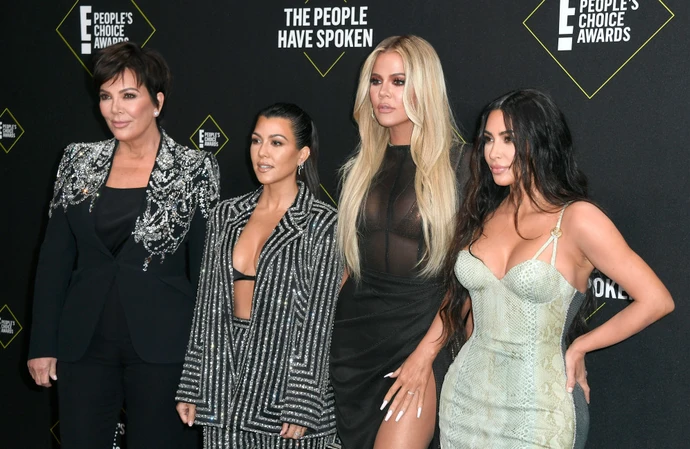 Kourtney Kardashian (second left) still hasn't introduced her baby to her family