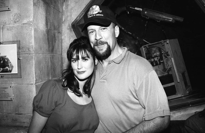 Bruce Willis’ wife Emma Heming Willis has posted a poignant throwback snap of the dementia-stricken actor in his heyday with his ex-partner Demi Moore