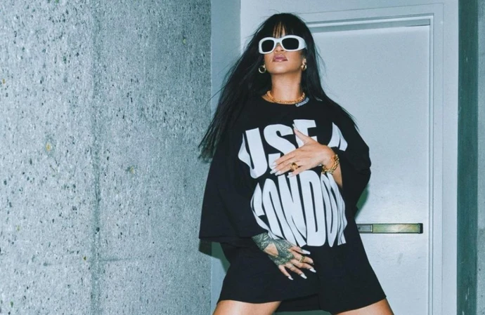 Heavily pregnant Rihanna has urged fans to buy her top emblazoned with the cheeky message: ‘Use a Condom’