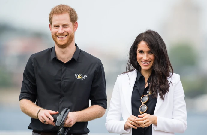 The Duke and Duchess of Sussex packed on the PDA as they cheered along with fans at the Invictus Games in Germany