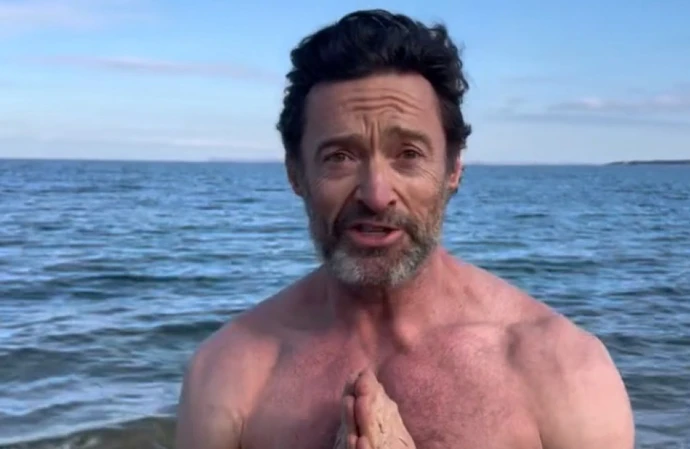 Hugh Jackman stripped to his trunks for a freezing sea swim on New Year’s Day
