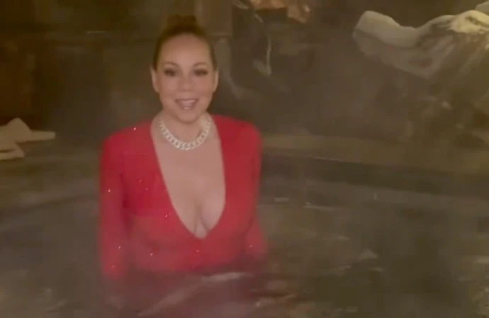 Mariah Carey has carried on her new year tradition of jumping into a jacuzzi in a posh frock