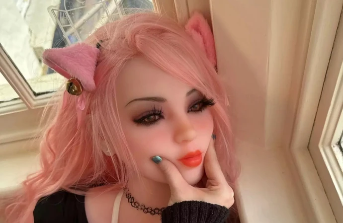 Belle Delphine is selling a sex doll with her likeness and has shared a snap of her groping its face