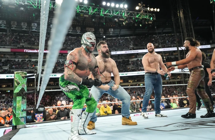 Rey Mysterio gets some help from two Philadelphia Eagles