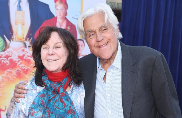 Jay Leno is standing by his wife Mavis