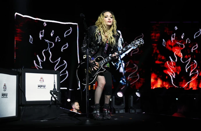 Madonna is being sued by a male fan for allegedly staging a sweaty pornography-style show