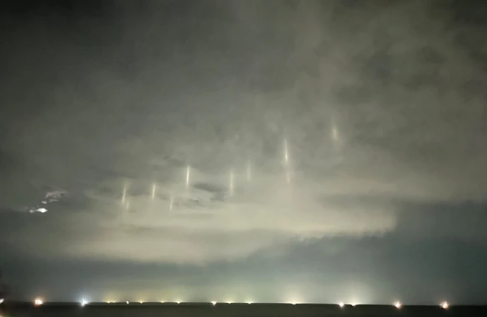 Locals in a small coastal town in Japan were left convinced aliens may be visiting Earth after nine bright pillars of light appeared in the night sky above the ocean
