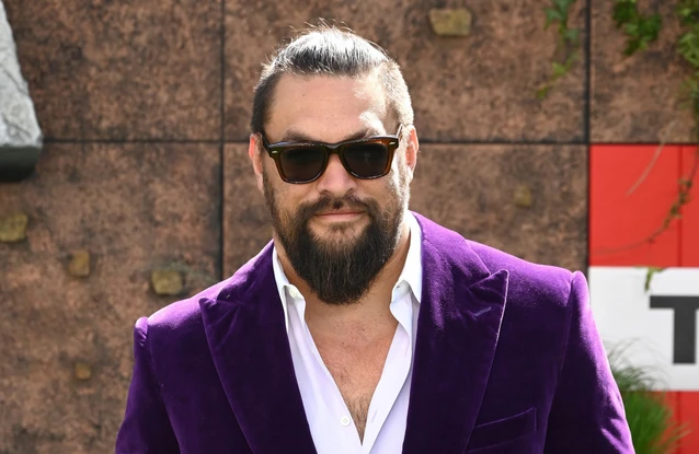 Jason Momoa is never without a hair scrunchie and likes to match them to his outfits and characters