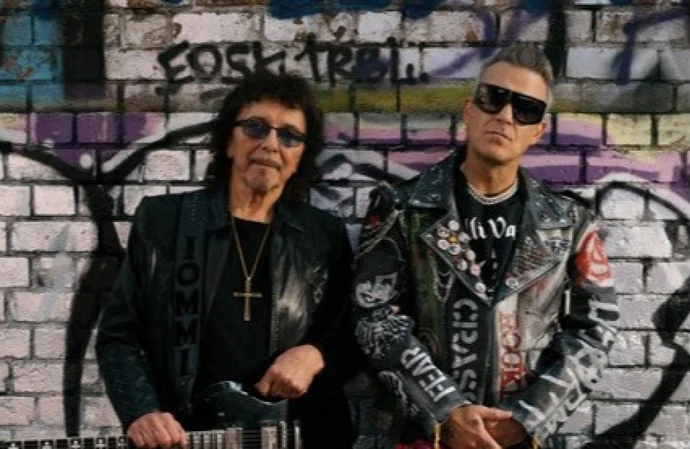 Robbie Williams rocks tartan pants and leather in the music video for 'Rocket'