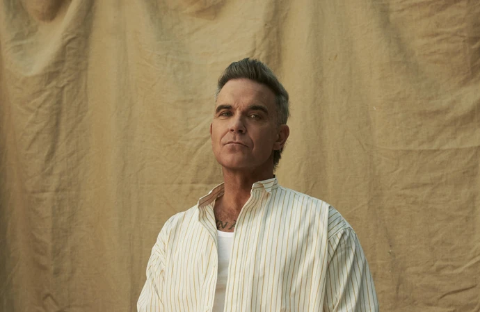 Robbie Williams has shared the guitar anthem Spies from his BRITPOP album