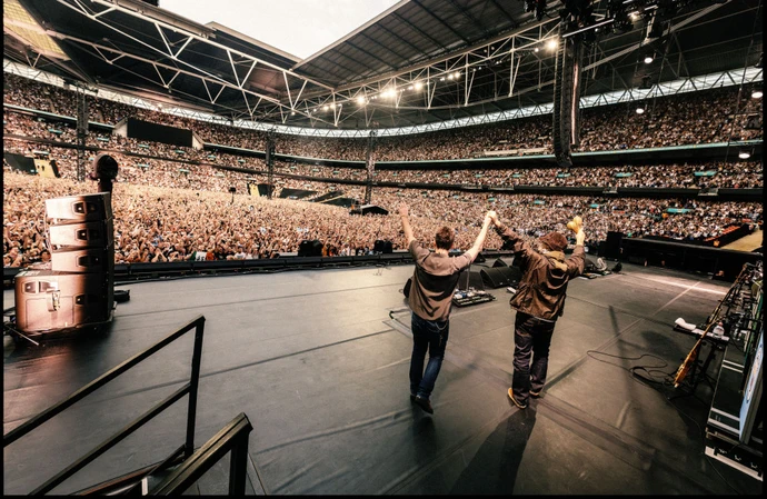 Liam Gallagher and Noel Gallagher take in the scenes at Wembley Stadium / Credit: Joshua Halling / Big Brother Recordings