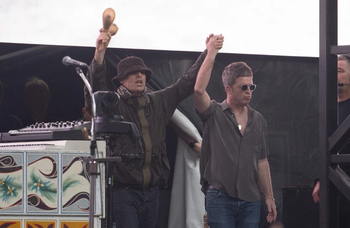Liam and Noel Gallagher on stage at Wembley Stadium on July 25
