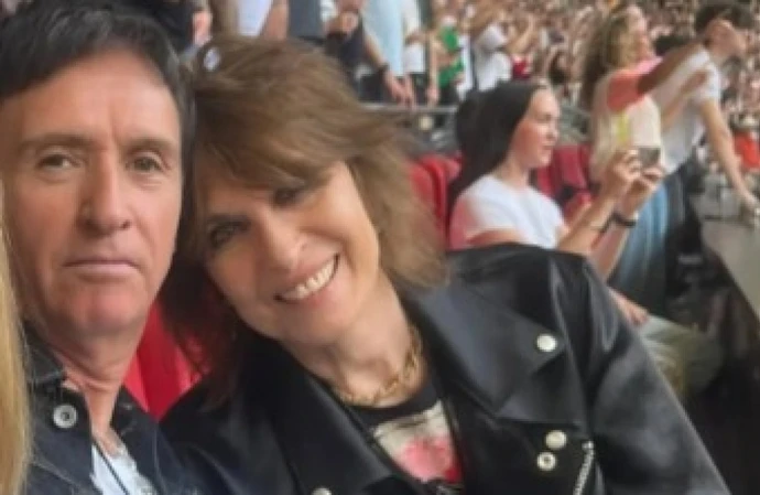 Chrissie Hynde was loving life at Oasis' Wembley gig with pal Johnny Marr