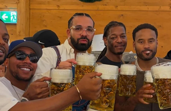 Drake has traded his beloved champagne for beer steins after travelling to Germany to celebrate Oktoberfest in traditional style