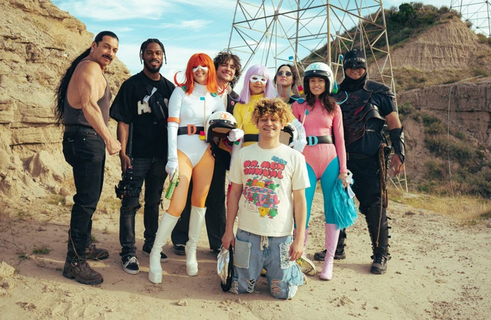 On set for Live Your Life, surrounded by friends - Dolo Tonight’s custom made world