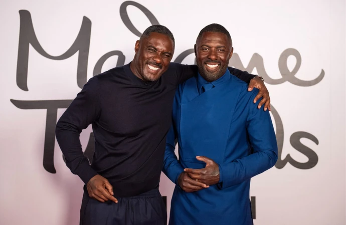 Idris Elba posing with his Madame Tussauds waxwork