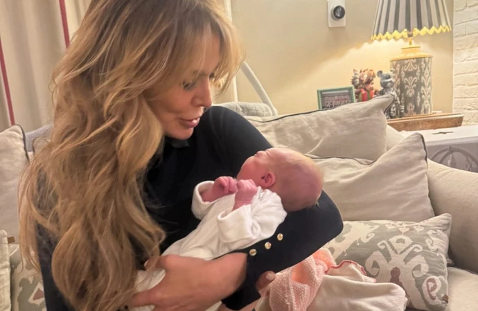 Lizzie Cundy cradling her niece's baby / © Instagram