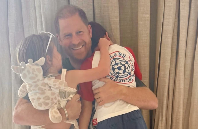 Prince Harry has posed for a heartfelt Father’s Day moment with his children Archie and Lilibet – with his son wearing an England football shirt