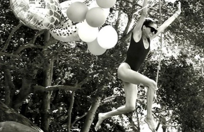 Meghan, Duchess of Sussex, has marked her 45th birthday by sharing playful photographs of herself leaping into a swimming pool clutching balloons