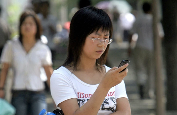 Adult with child using phone