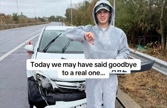 Harry Clark in front of his wrecked white Vauxhall Corsa / © Instagram